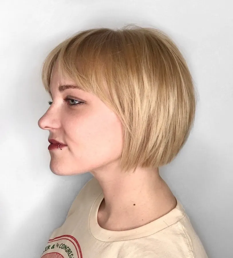 Rounded blonde graduated chin-length bob with a soft side fringe