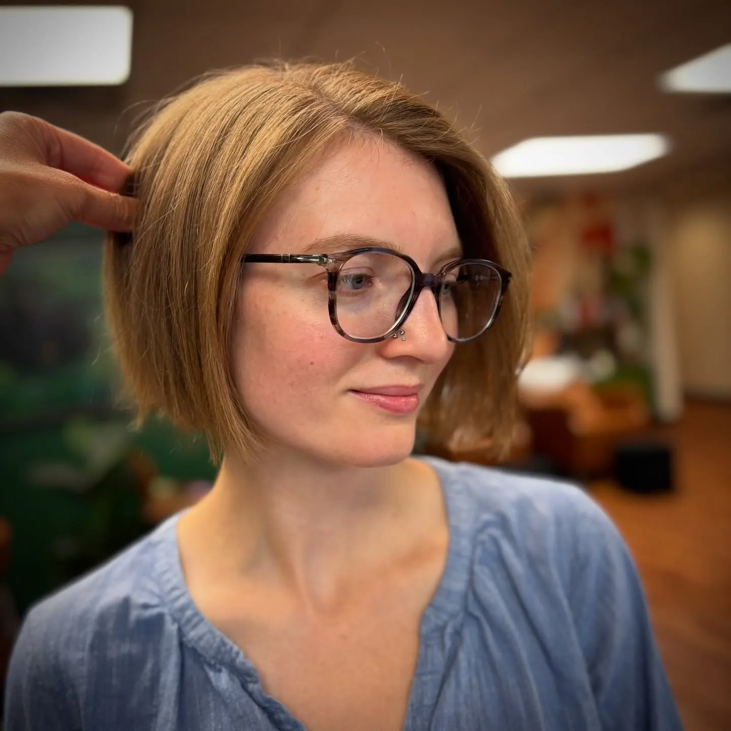 Smooth light brown chin-length bob with a soft side part