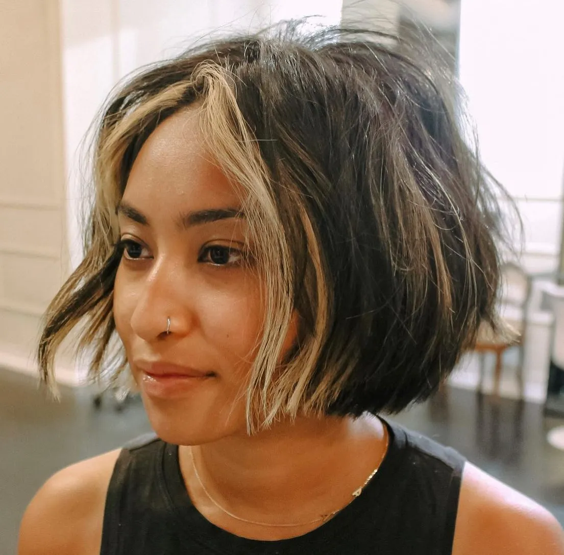 Textured dark chin-length bob with light face-framing sections