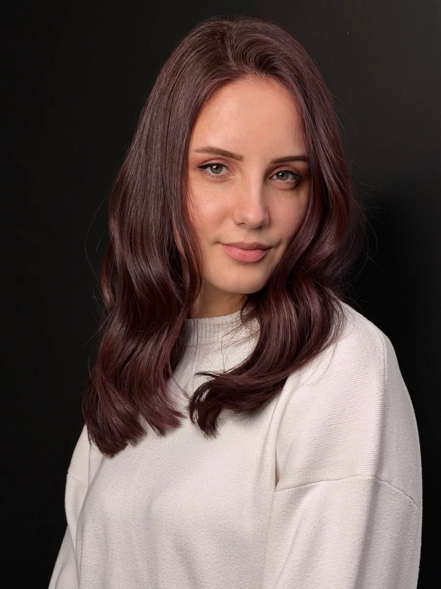 Shoulder-length wavy lob with soft burgundy red-brown color