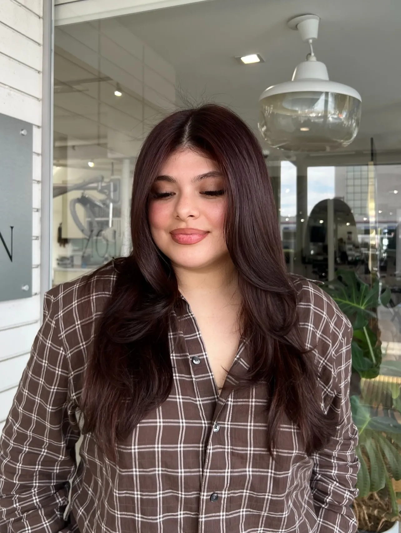 Long layered hair with a deep burgundy red-brown color