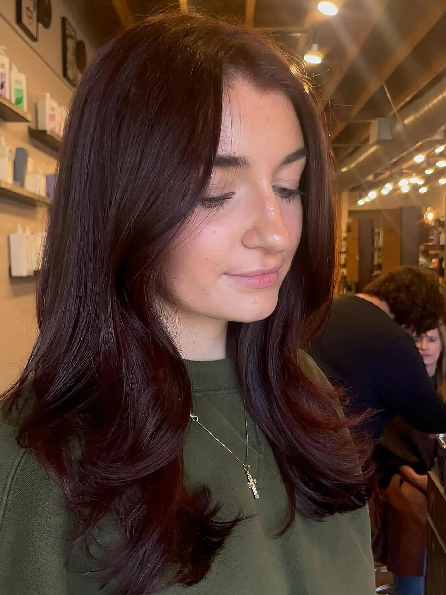 Dark red-brown layered hair with curled ends