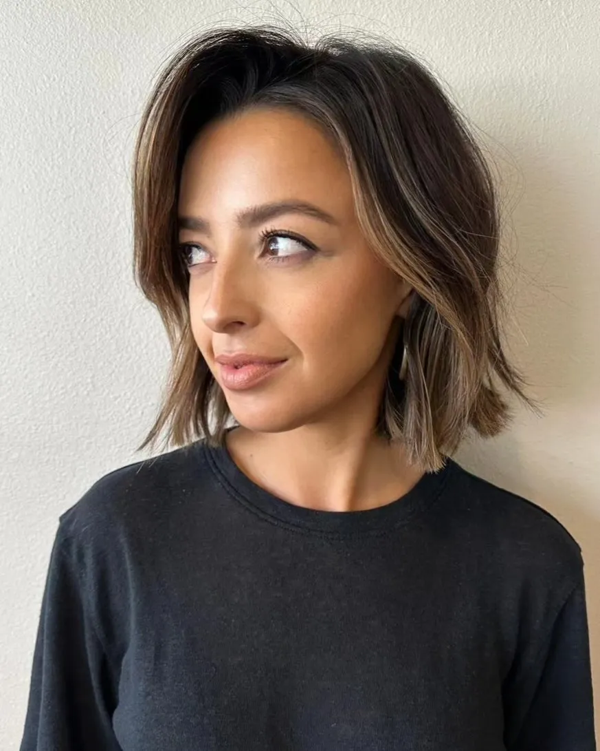 Side-parted choppy bob with face-framing layers
