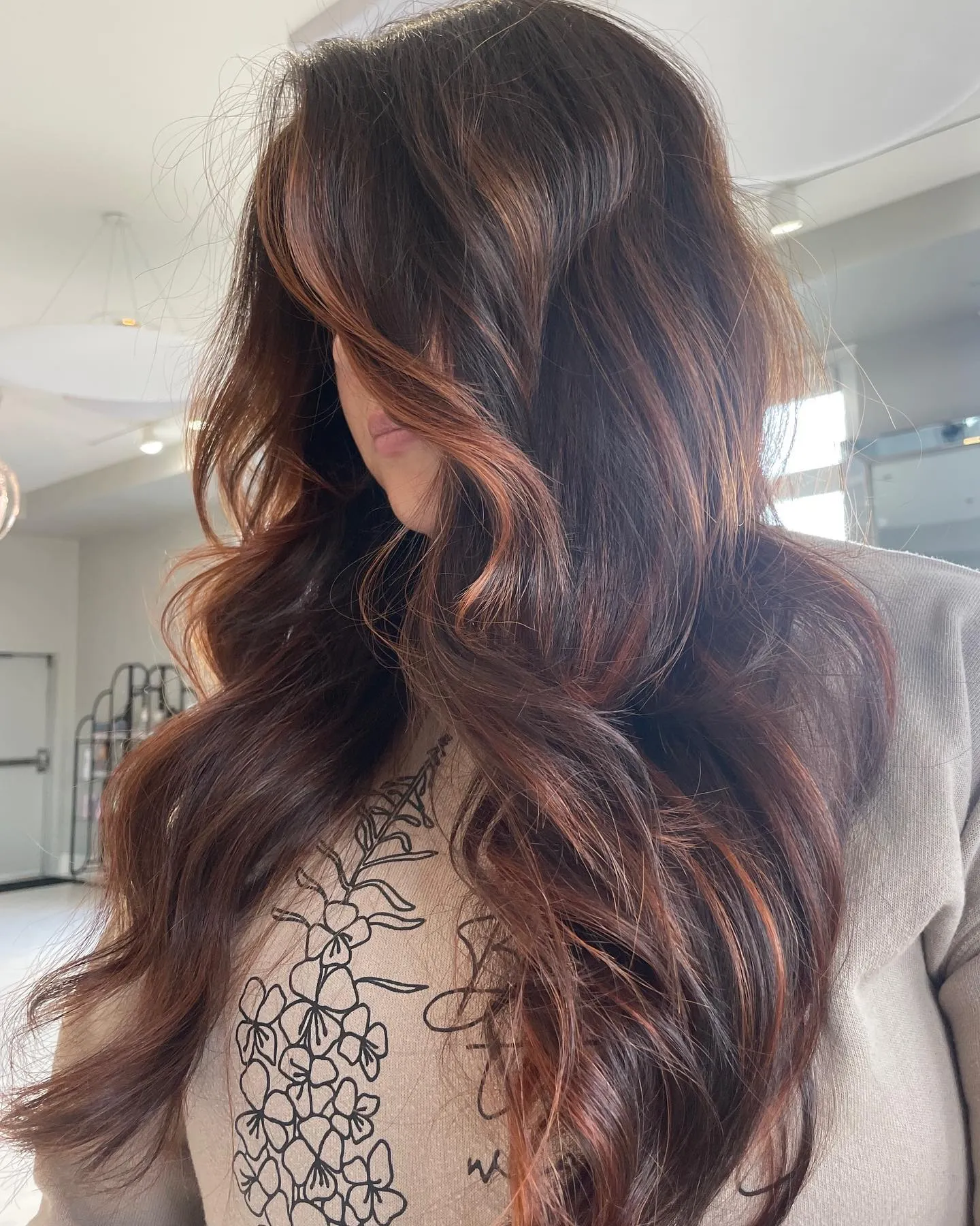 Deep brunette layers with subtle copper face-framing pieces