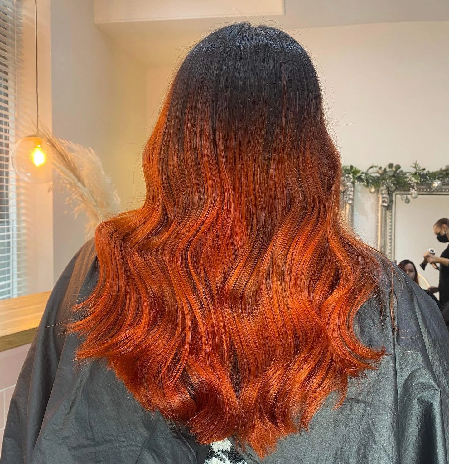 Long copper melt with dark roots and soft waves