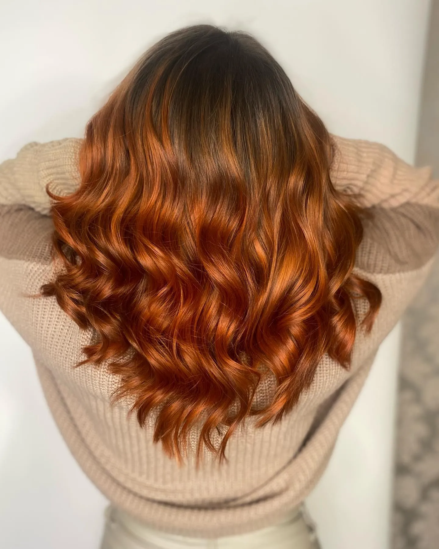 Rich copper balayage with darker roots and glossy waves