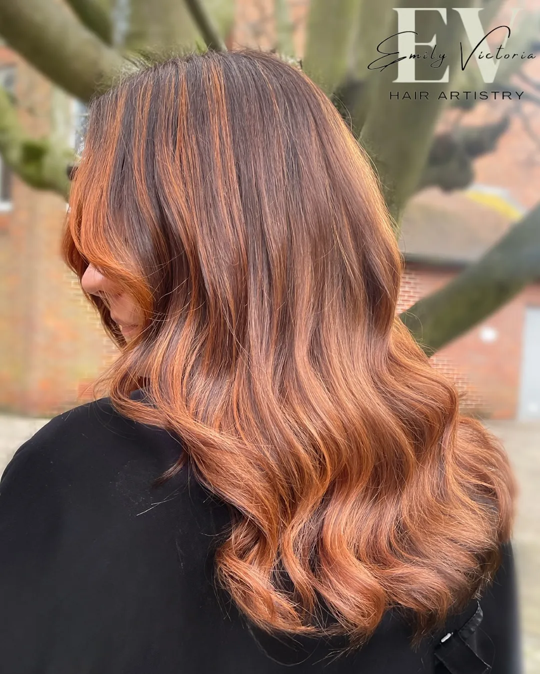 Soft copper balayage blended through long brown waves
