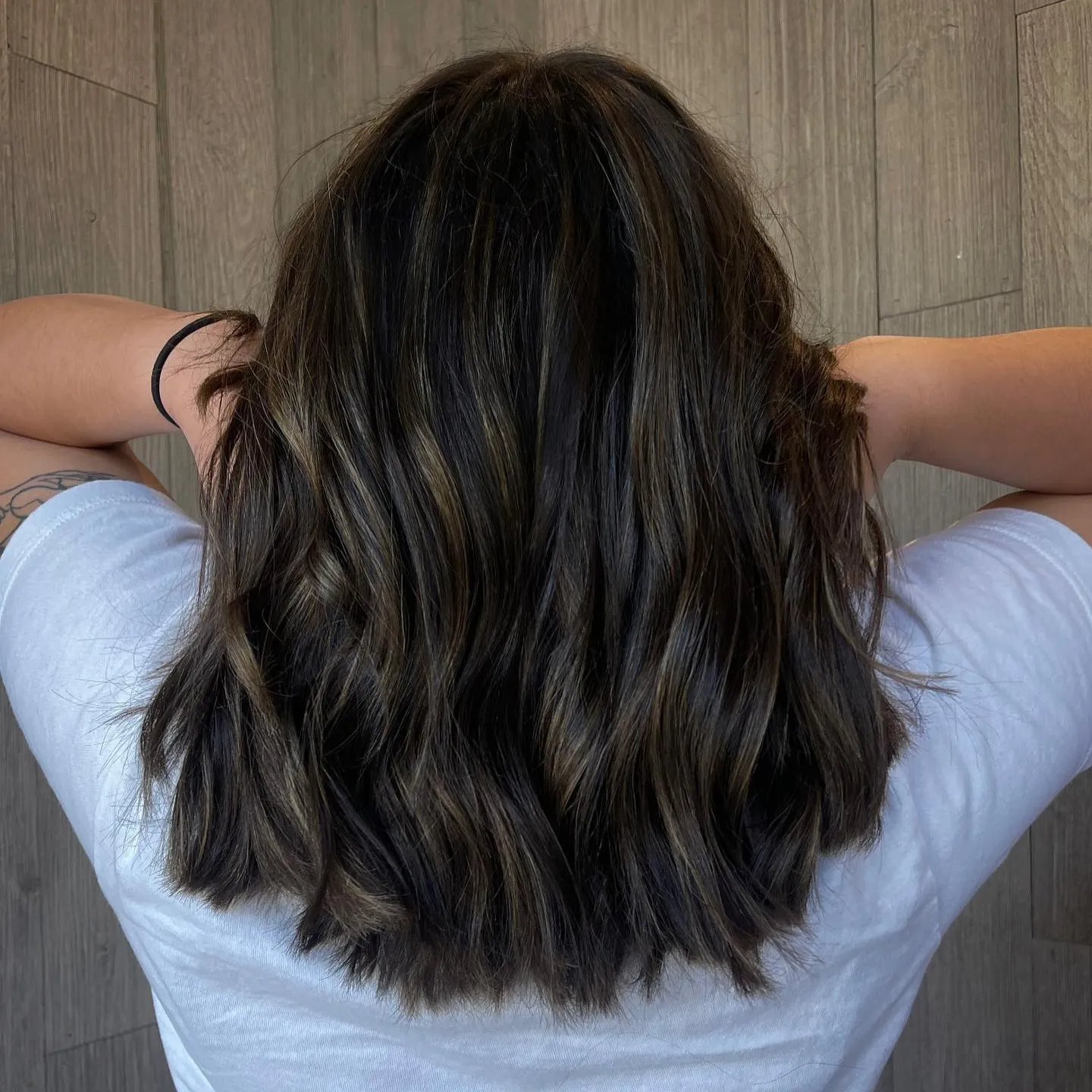 Back view of medium dark brown layered waves