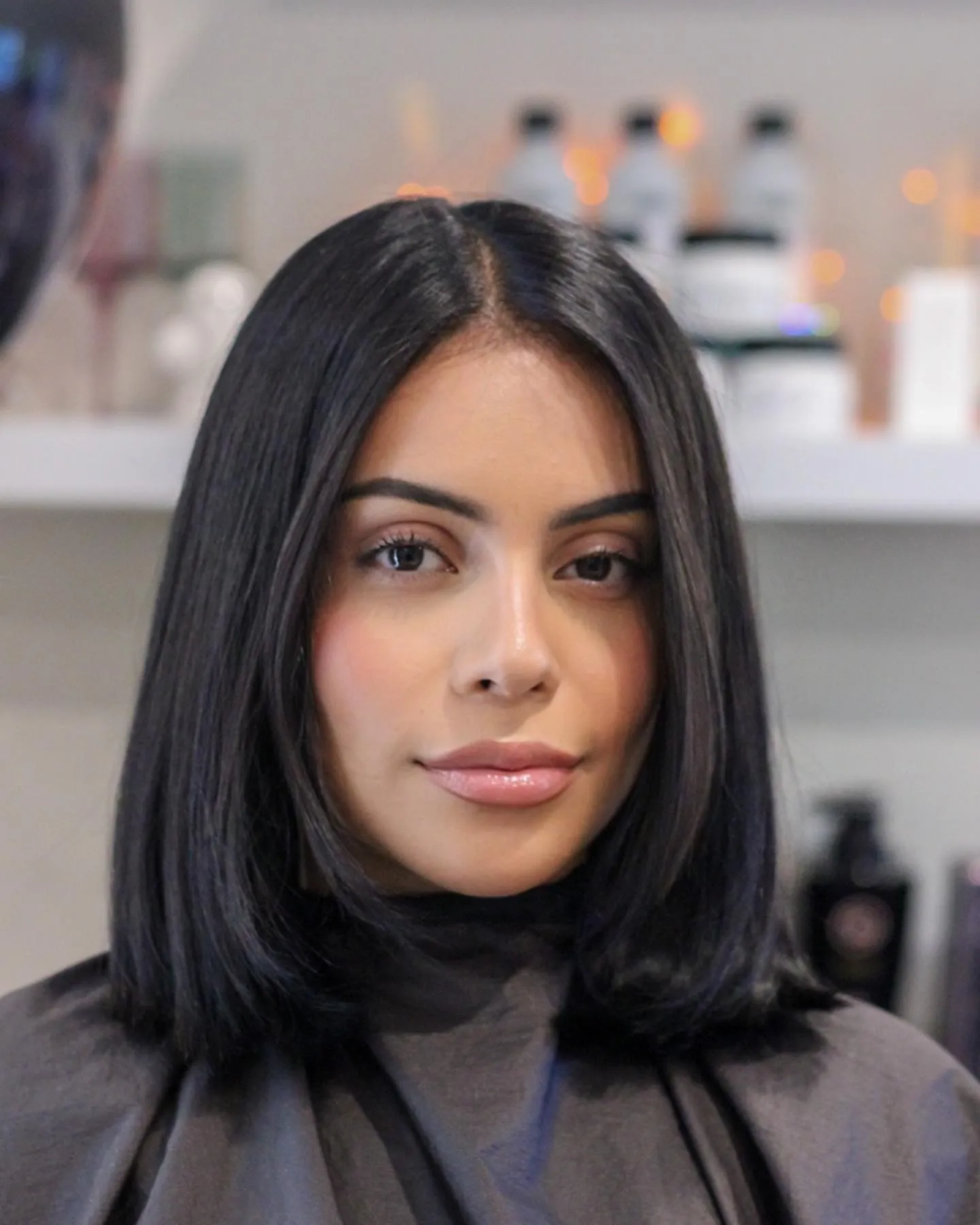 Sleek straight black bob with center part