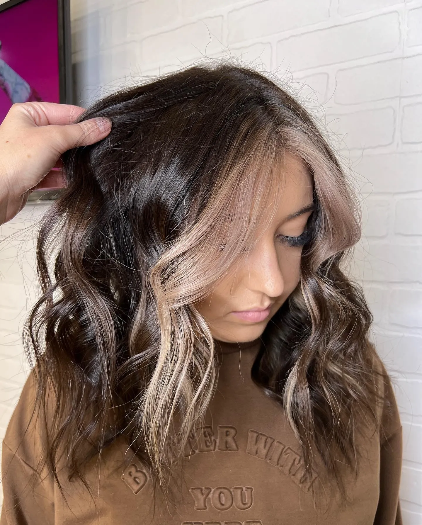 Dark wavy hair with ash blonde face-framing pieces