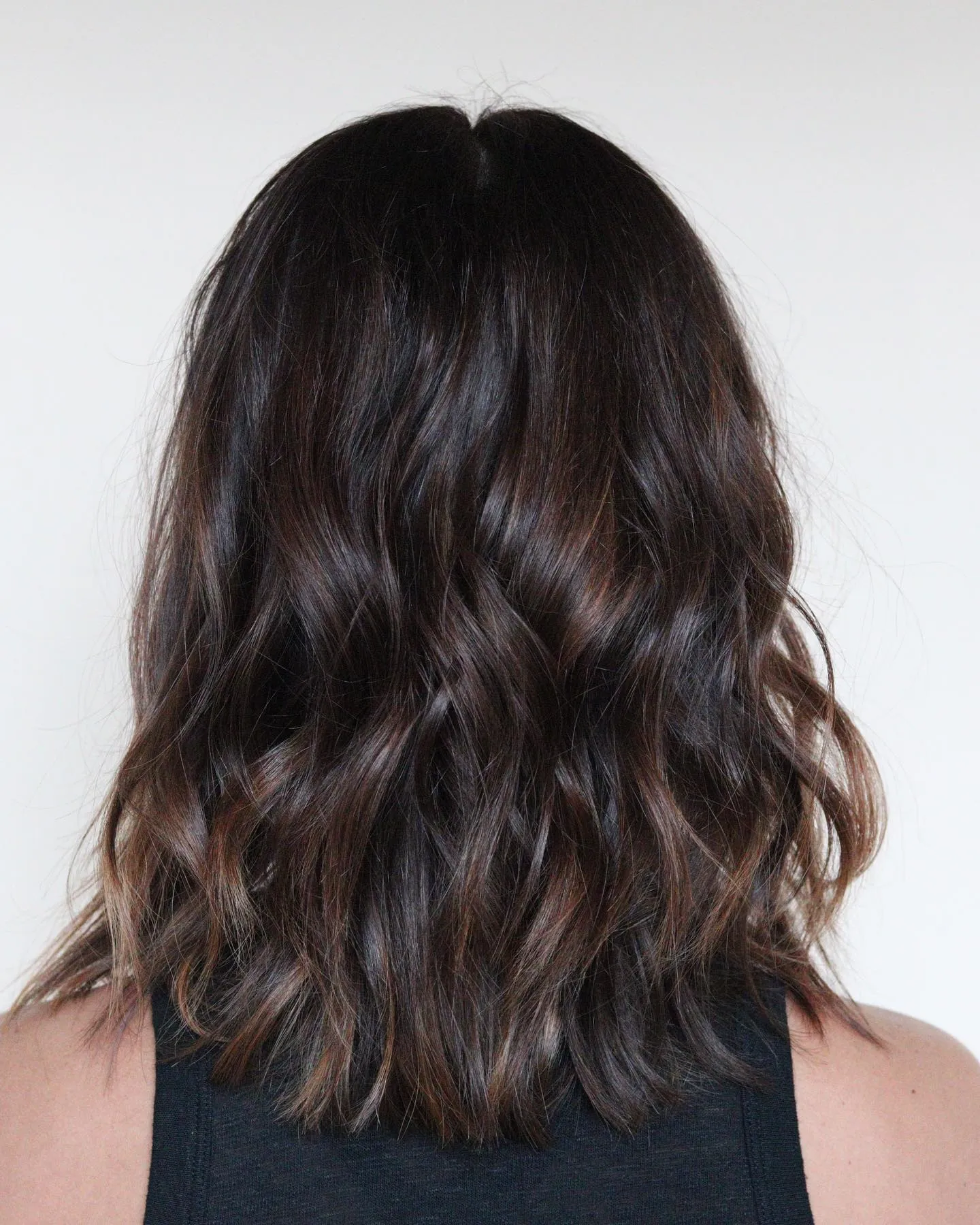 Back view of soft dark brown wavy lob