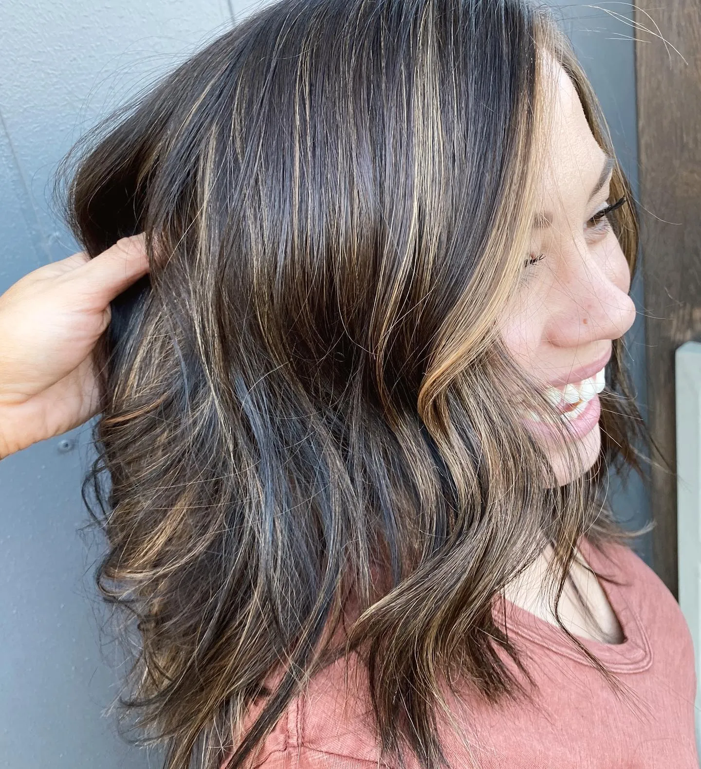 Medium dark brown lob with caramel highlights and soft waves