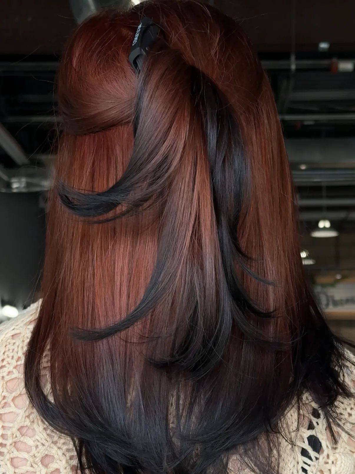 Back view of layered copper to dark red hair
