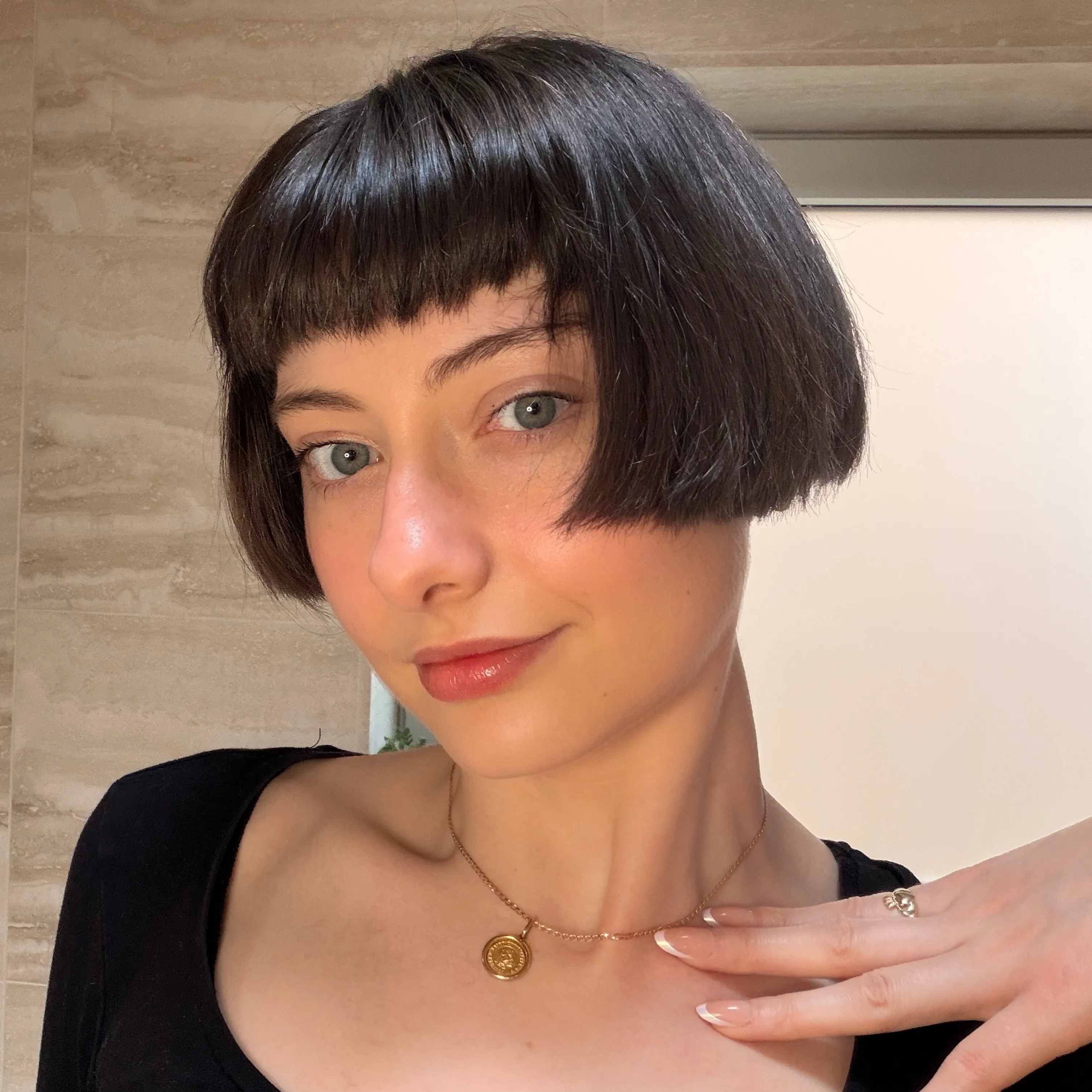 Glossy dark blunt ear-length bob with short straight fringe