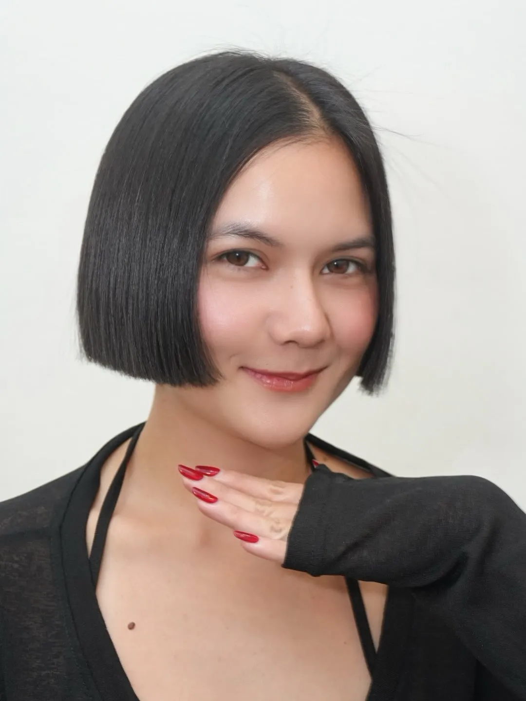 Sleek black jawline bob with a precise centre part