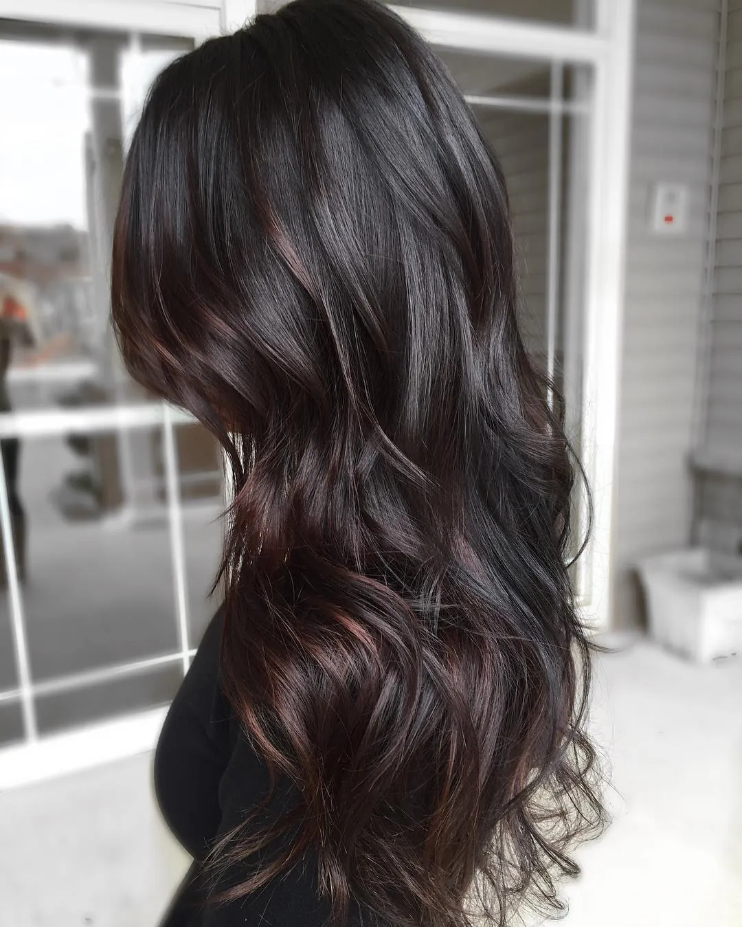 Long near-black brunette hair with soft waves viewed from the back