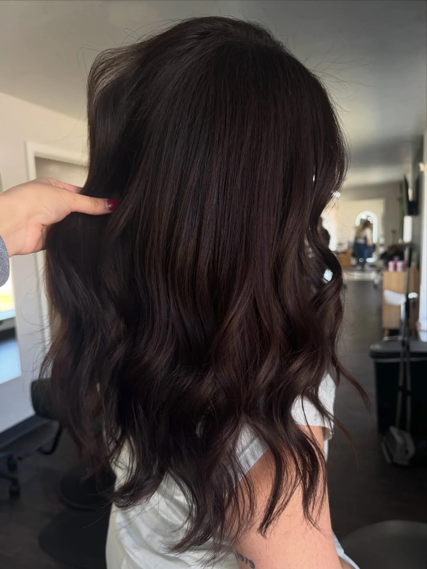 Long dark brunette hair with soft loose waves viewed from the back