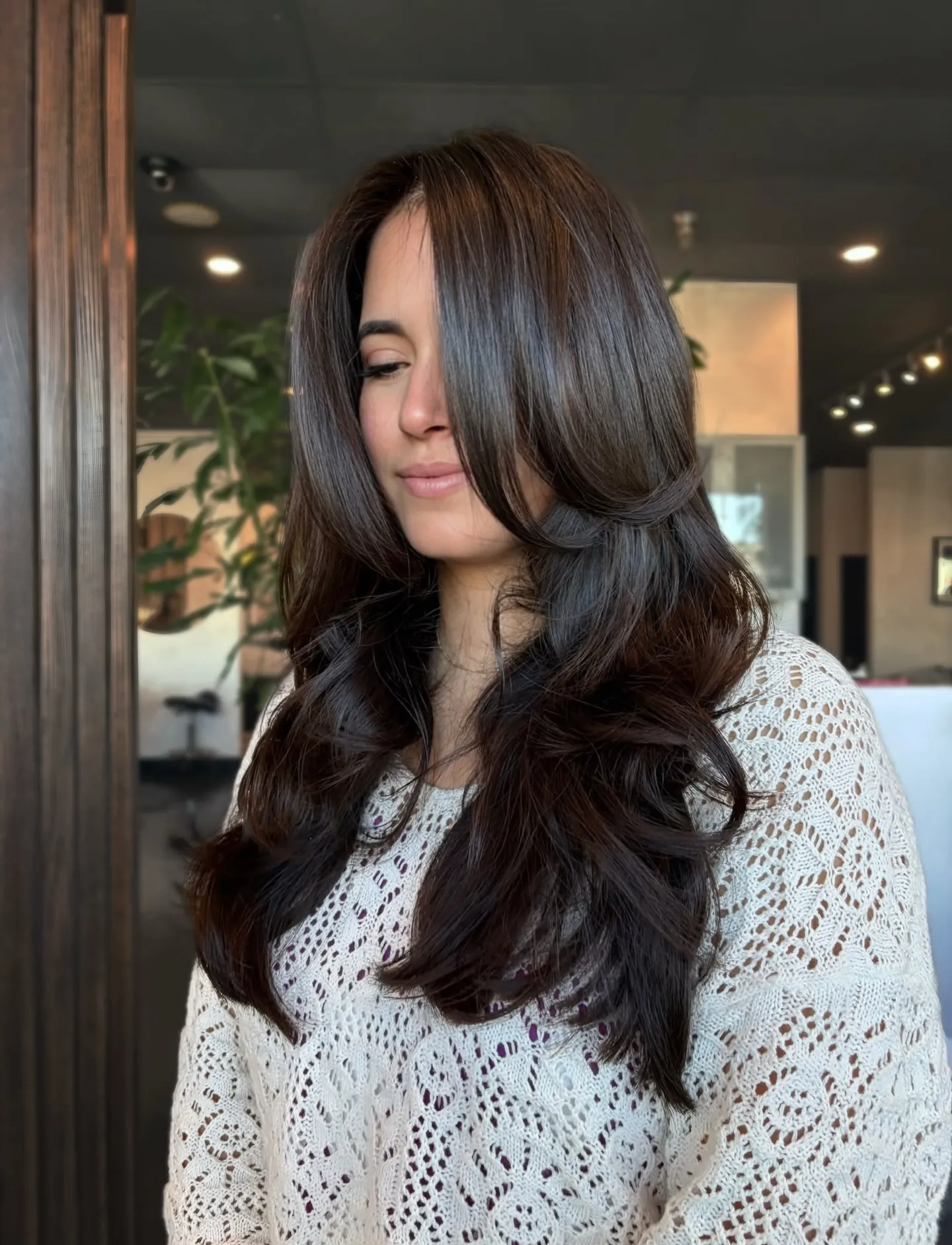 Long deep brunette hair with swooping face-framing layers