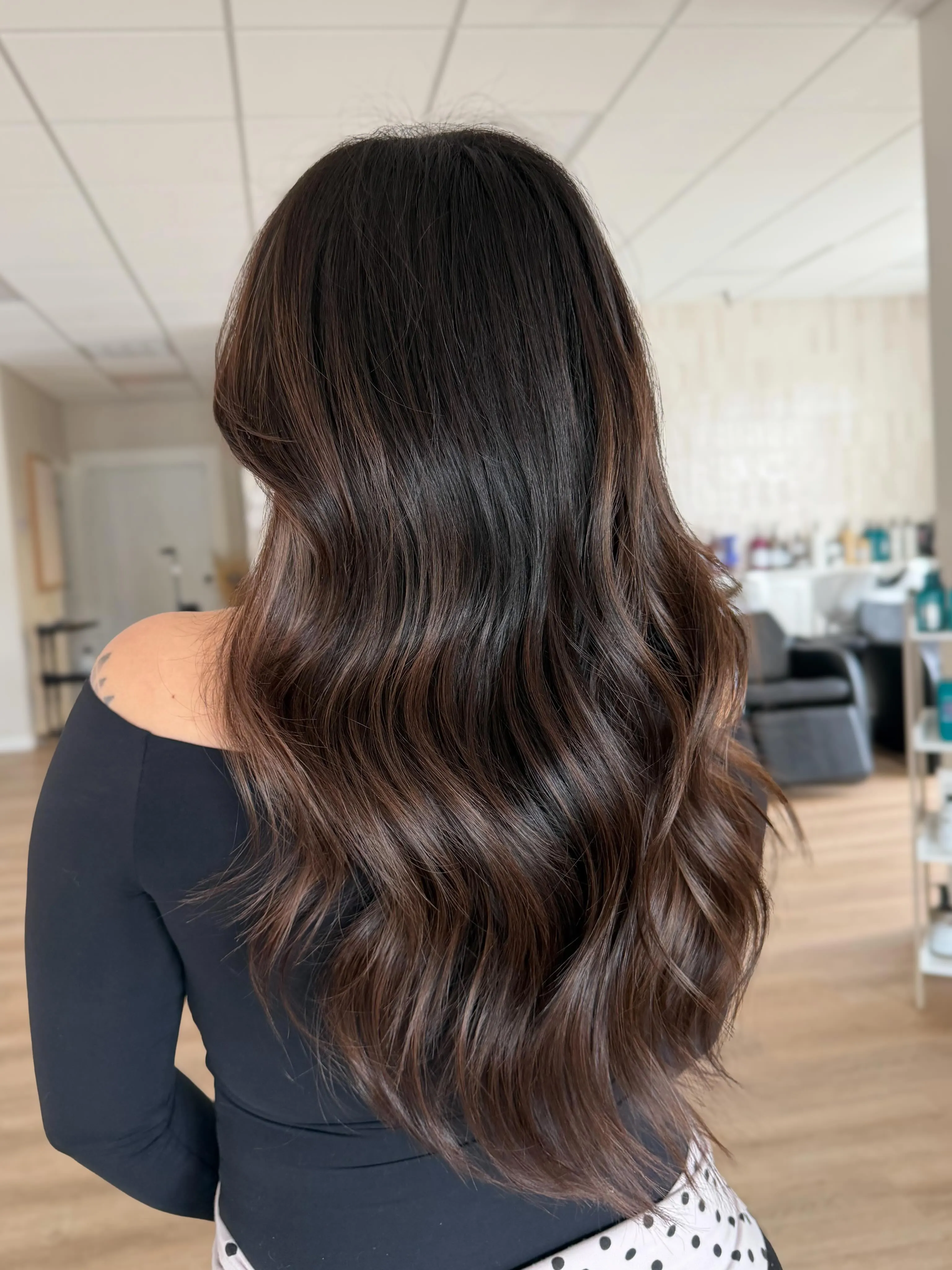 Long glossy brunette waves viewed from the back