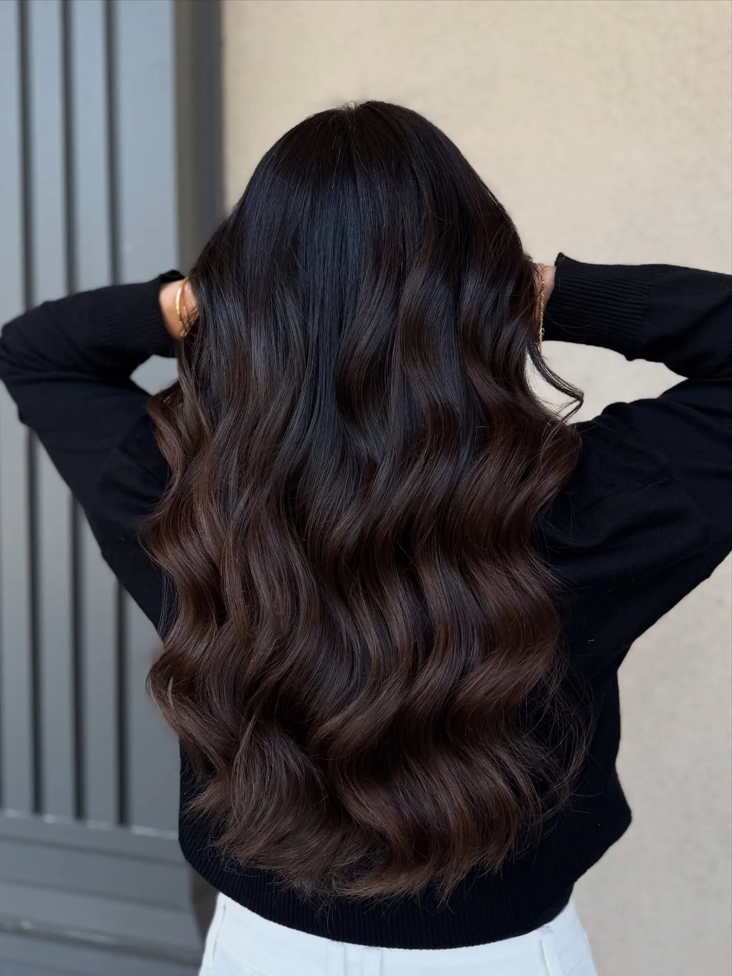 Very long deep brunette hair with sculpted waves viewed from the back