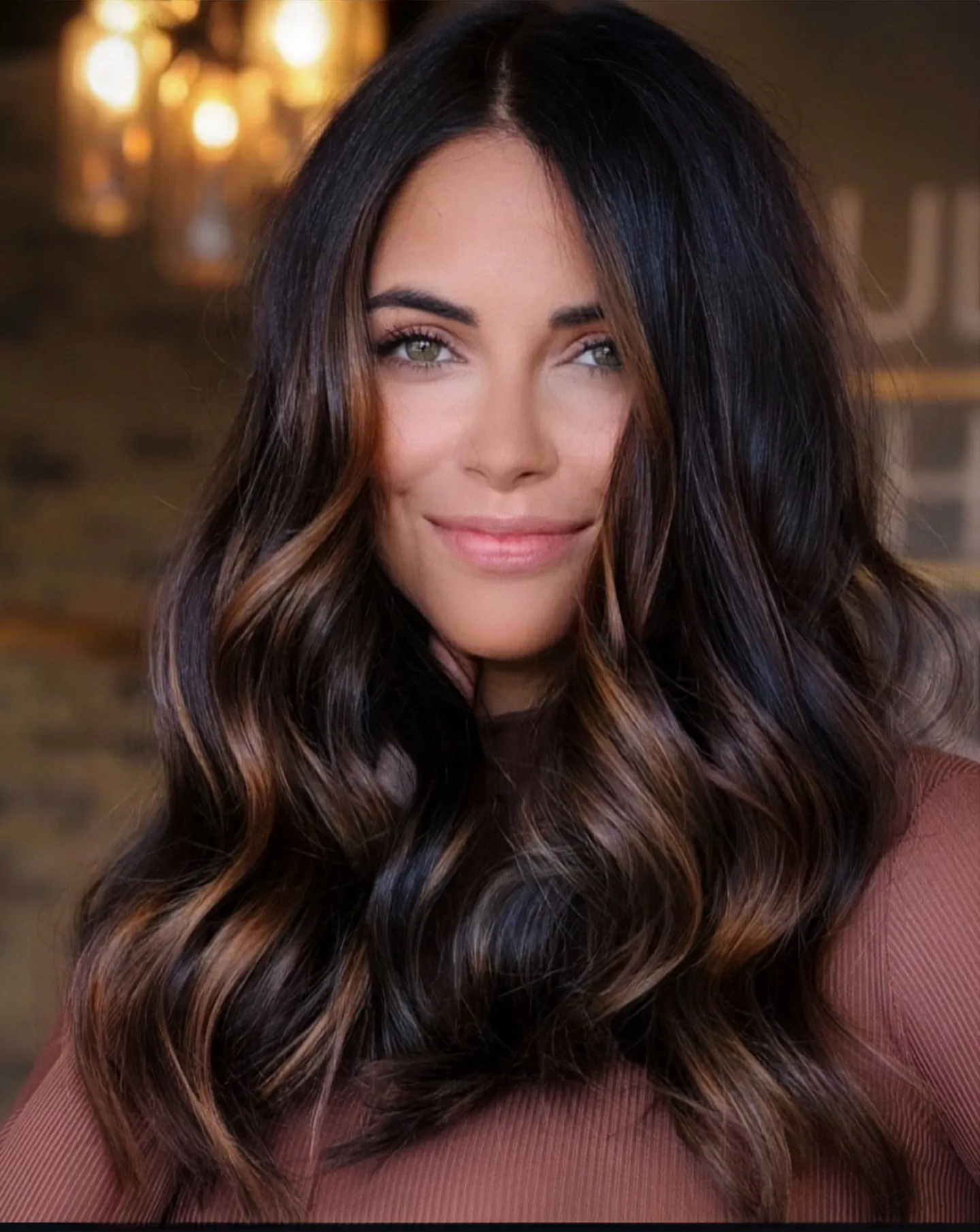 Long glossy dark brunette waves with a center part