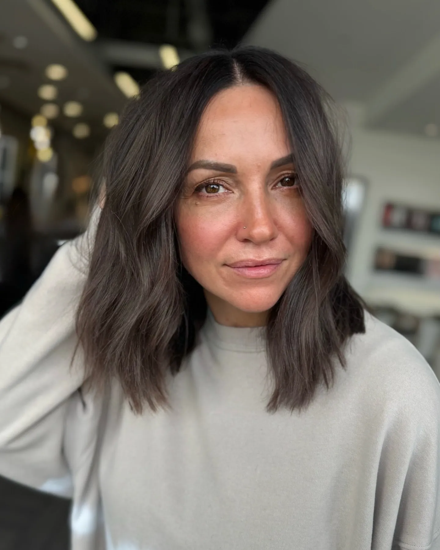 Straight shoulder-length dark brunette lob with a center part