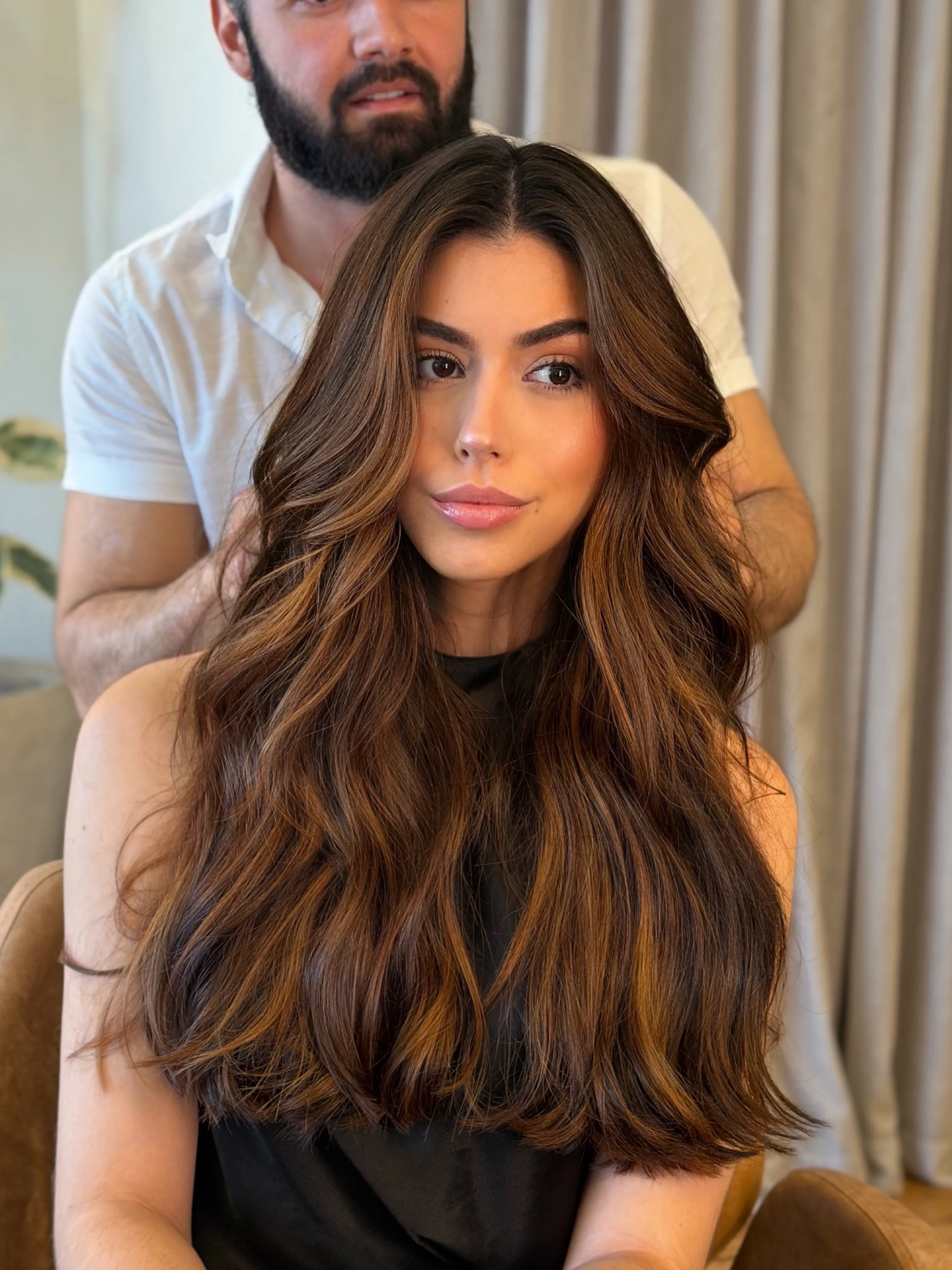 Long brunette hair with warm ribbon balayage and face framing