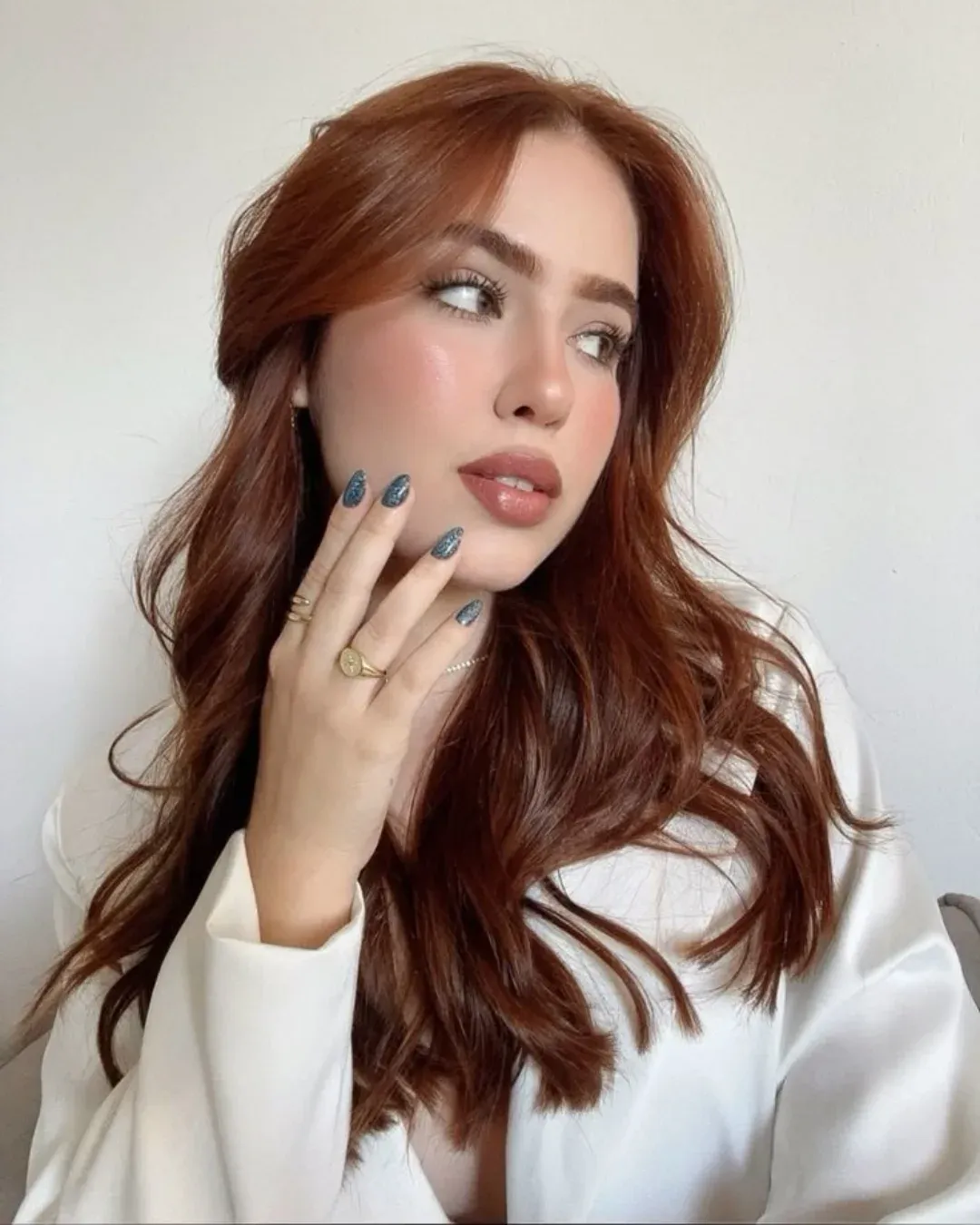 Warm auburn hair with loose waves and curtain fringe