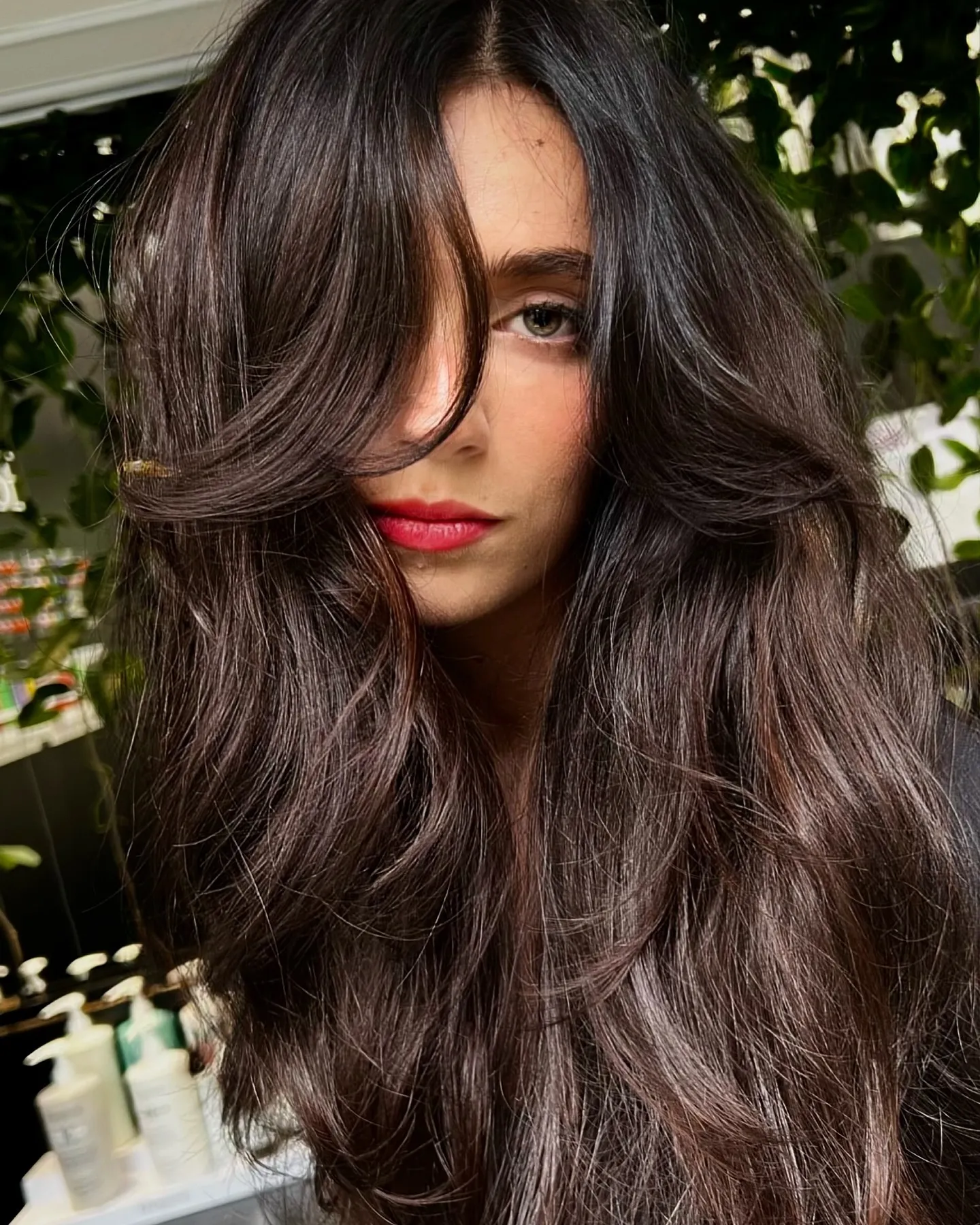 Voluminous dark brunette hair with face-framing layers