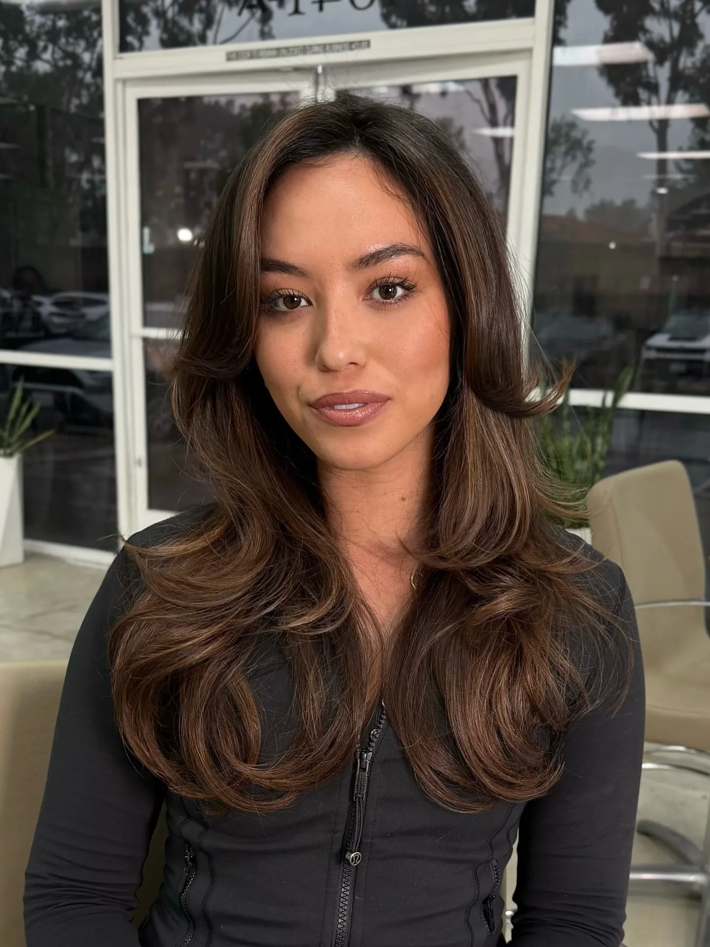 Glossy layered brunette hair with face-framing pieces