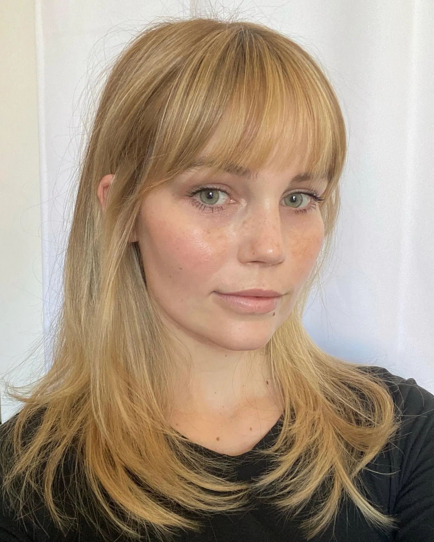 Golden blonde medium length with full bangs