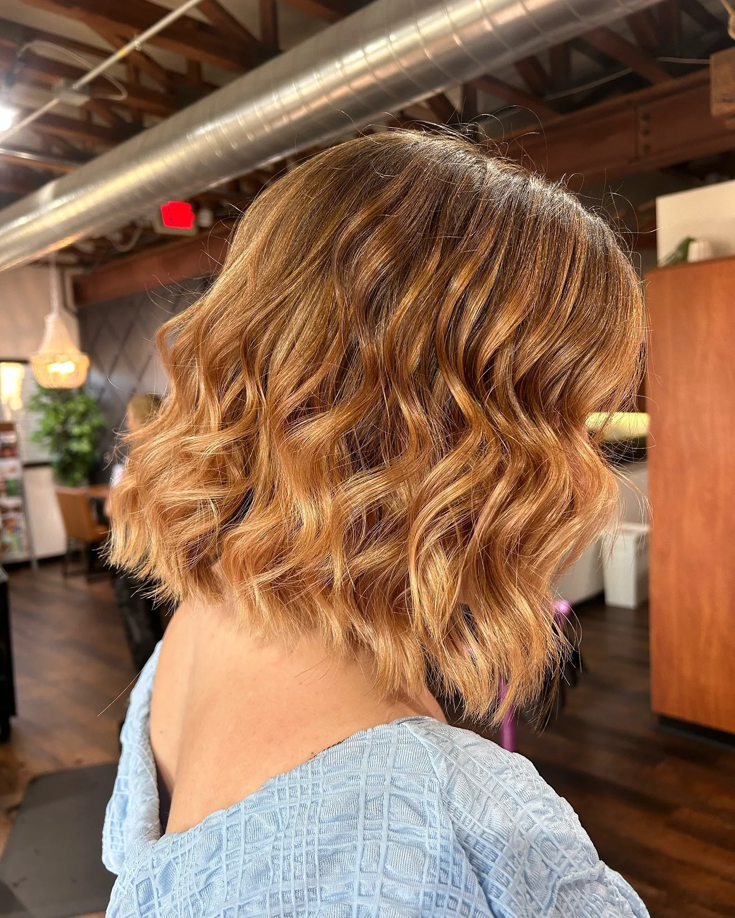 Short wavy copper-blonde bob from the back