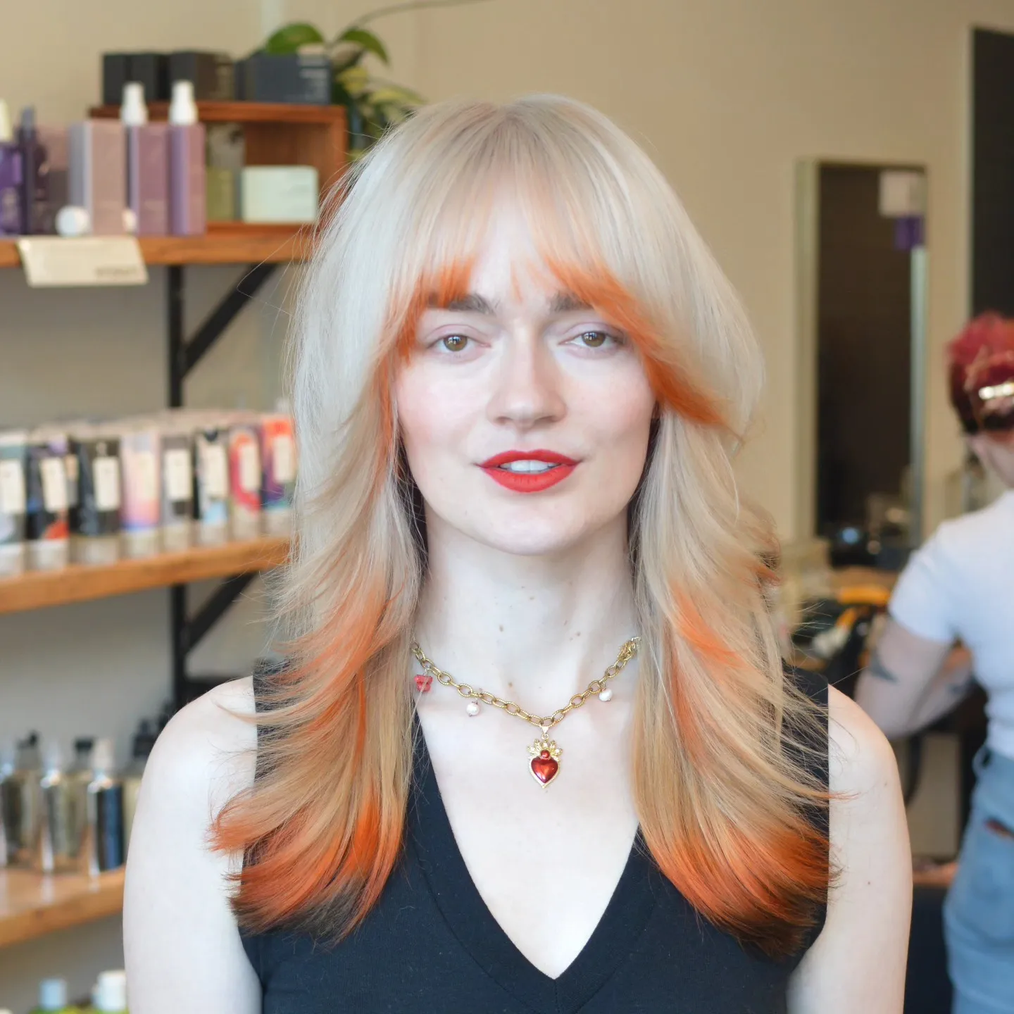 Pale blonde with orange-red face framing and ends