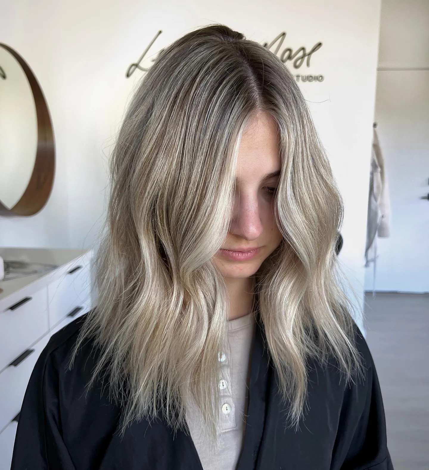 Cool ash blonde medium waves with center part