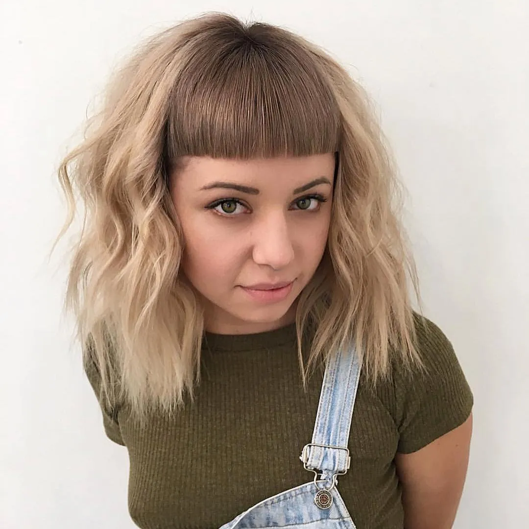 Blonde wavy bob with straight fringe