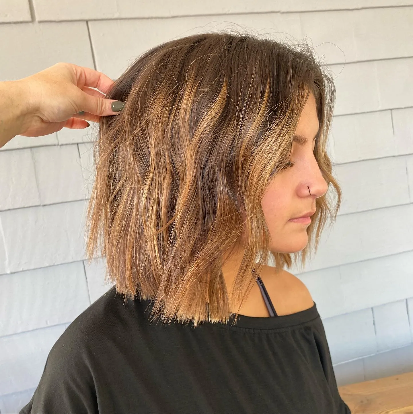 Tousled highlighted bob with face-framing pieces