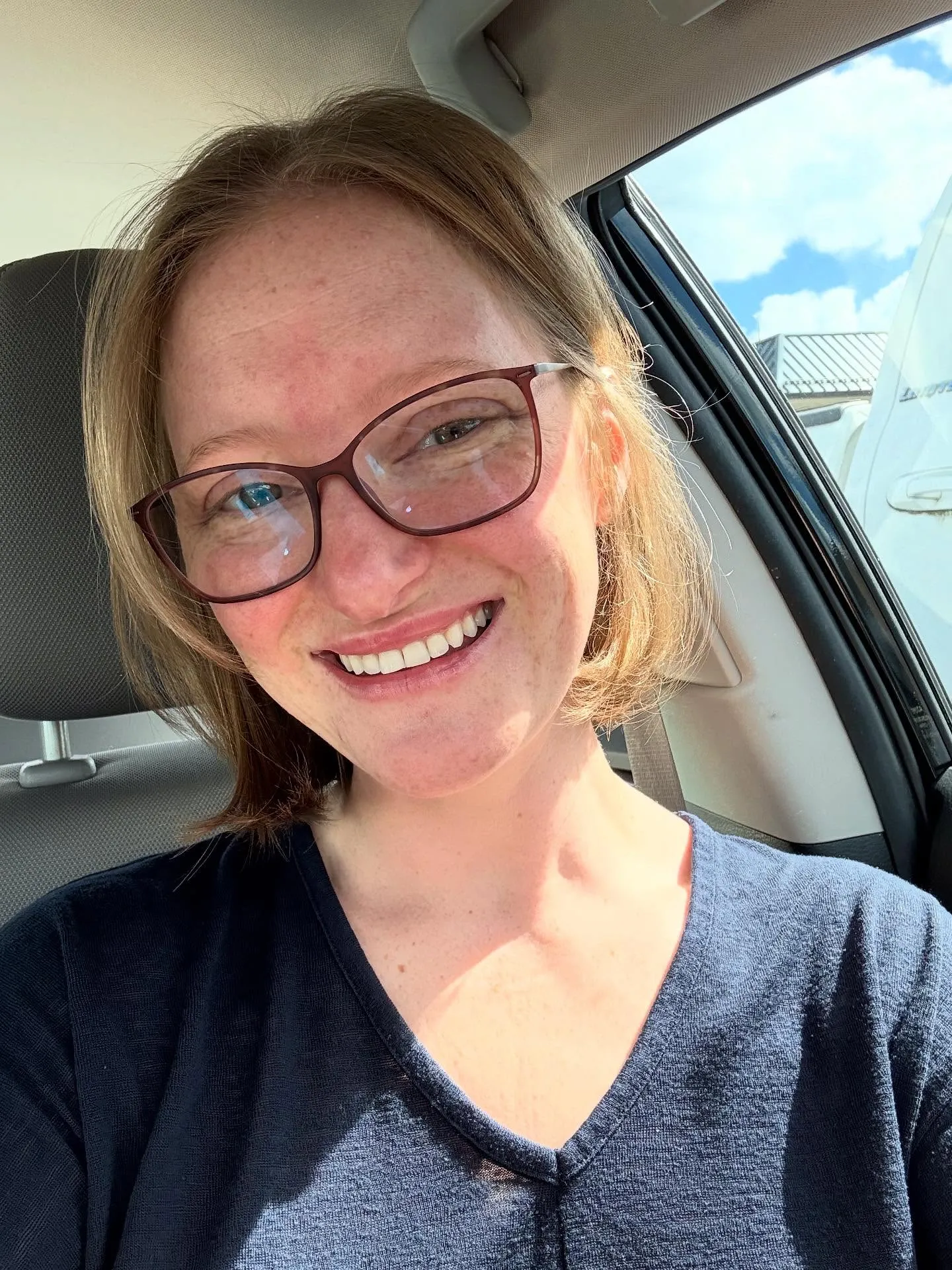 Short blonde bob tucked behind the ear