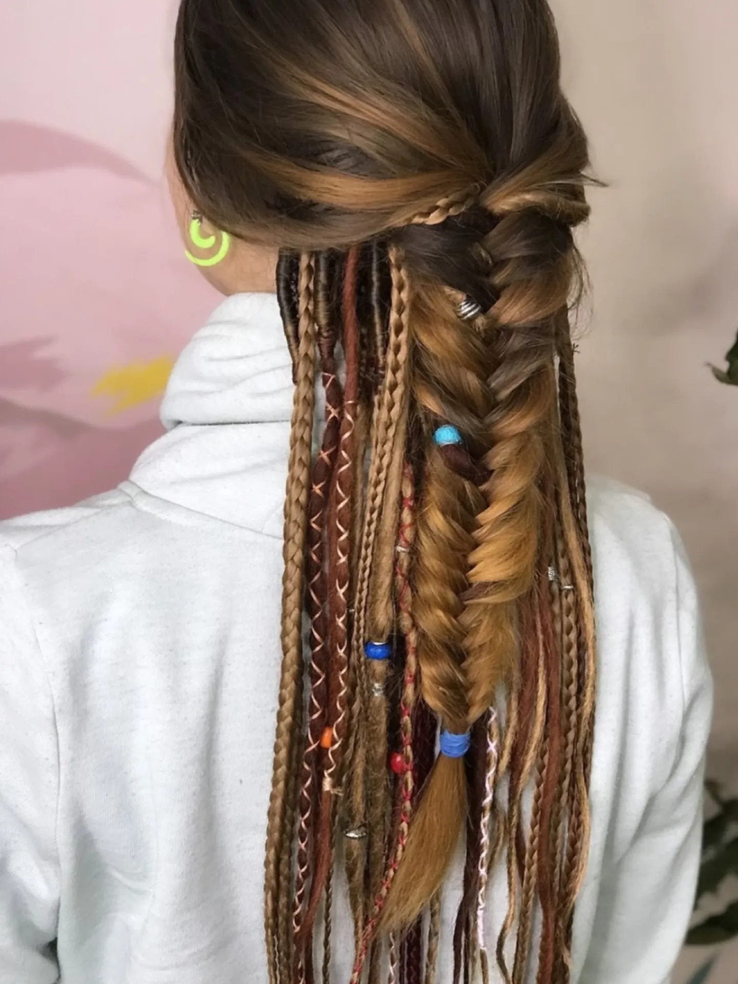 Long low braid finished with a large dark red flower