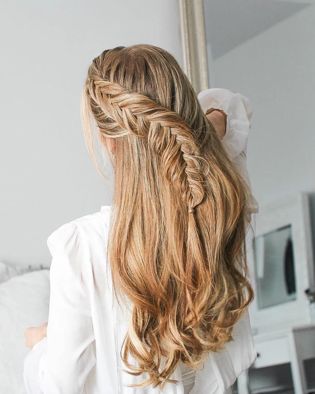 Two detailed Dutch braids merging into one long braid