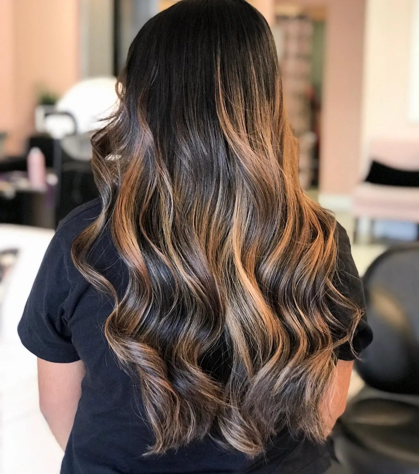 Long dark brown with caramel balayage ends and soft waves