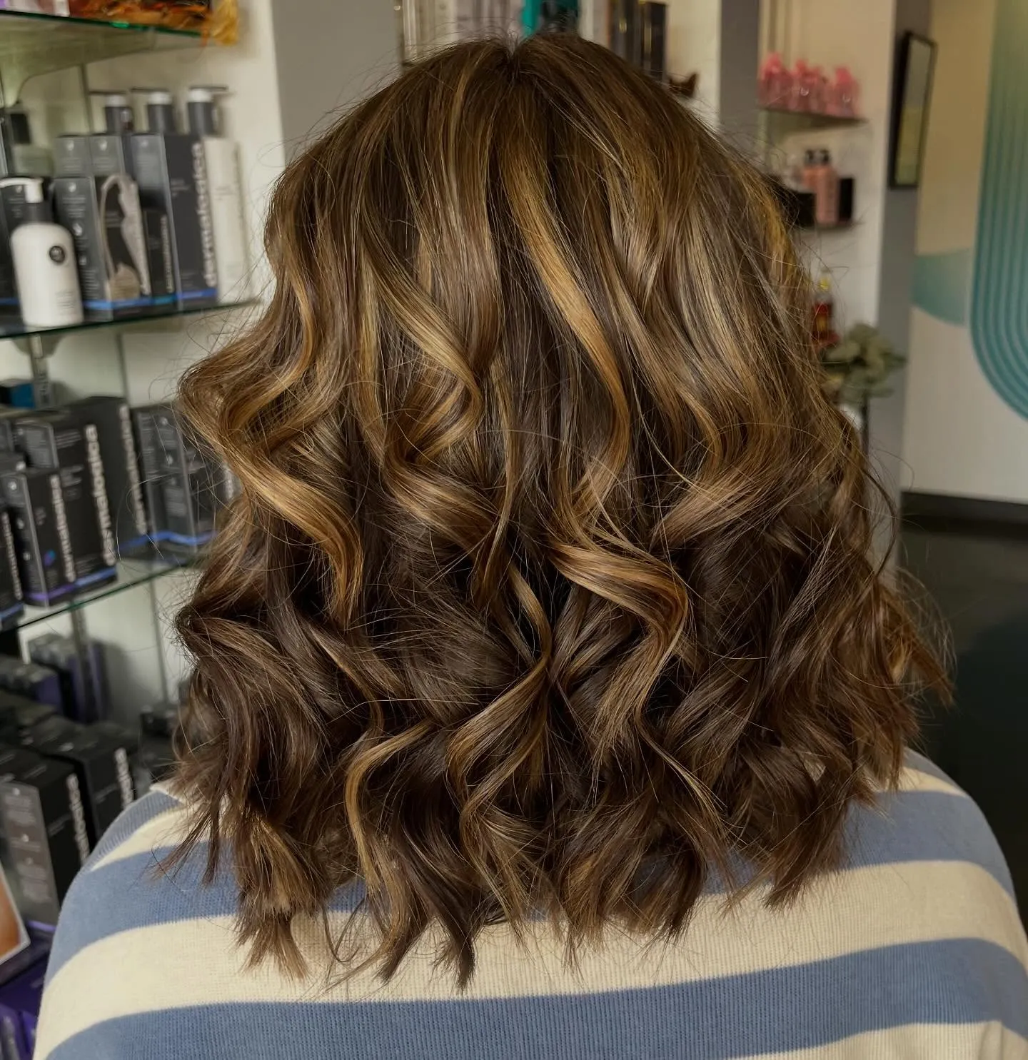 Medium brown with caramel highlights and curly waves