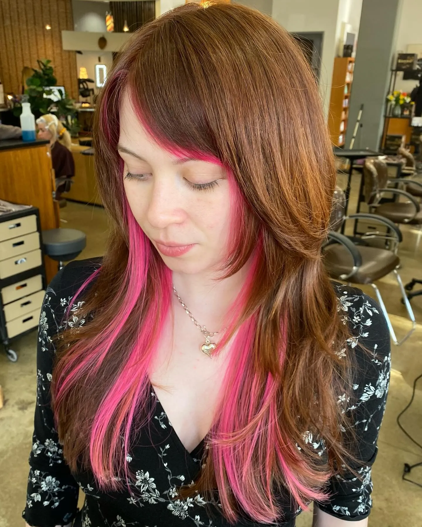 Brown hair with bright pink face-framing streaks