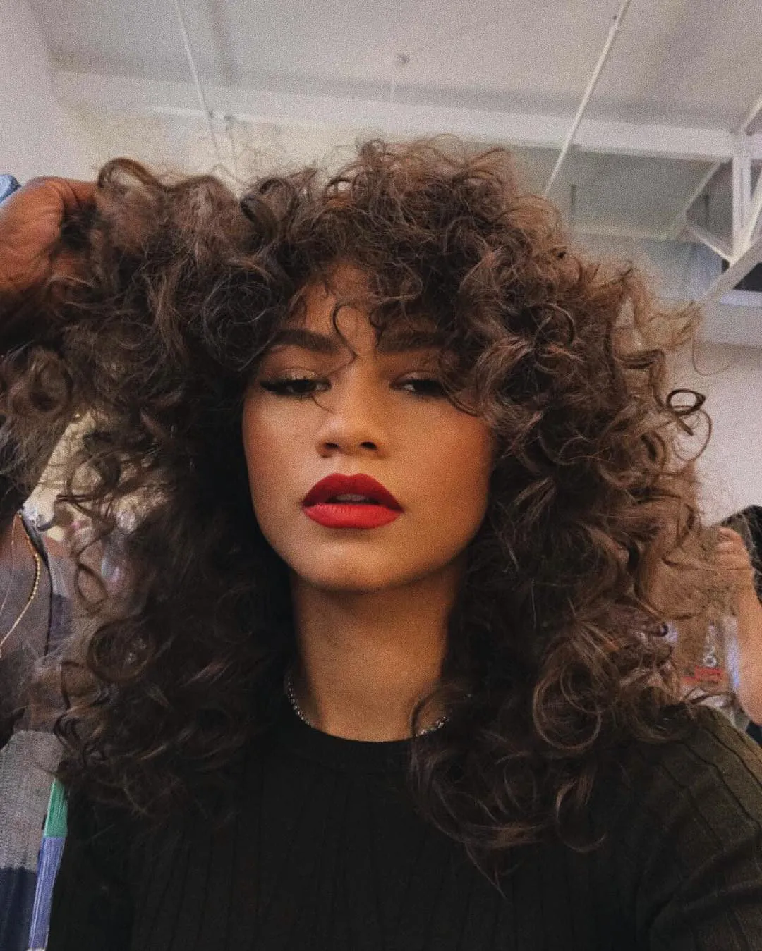 Long voluminous curls with a full curly fringe
