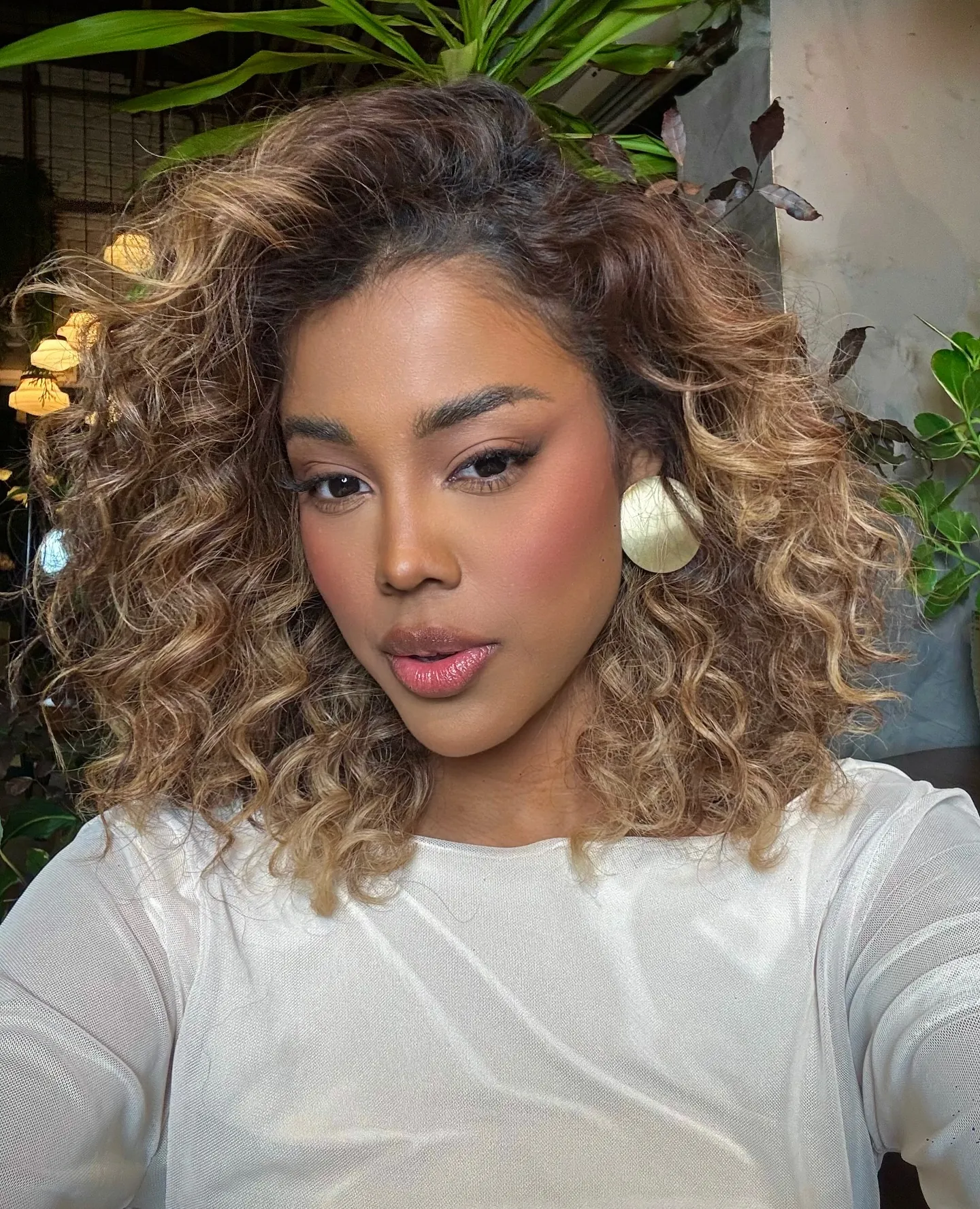 Side-parted curly lob with lighter face-framing pieces