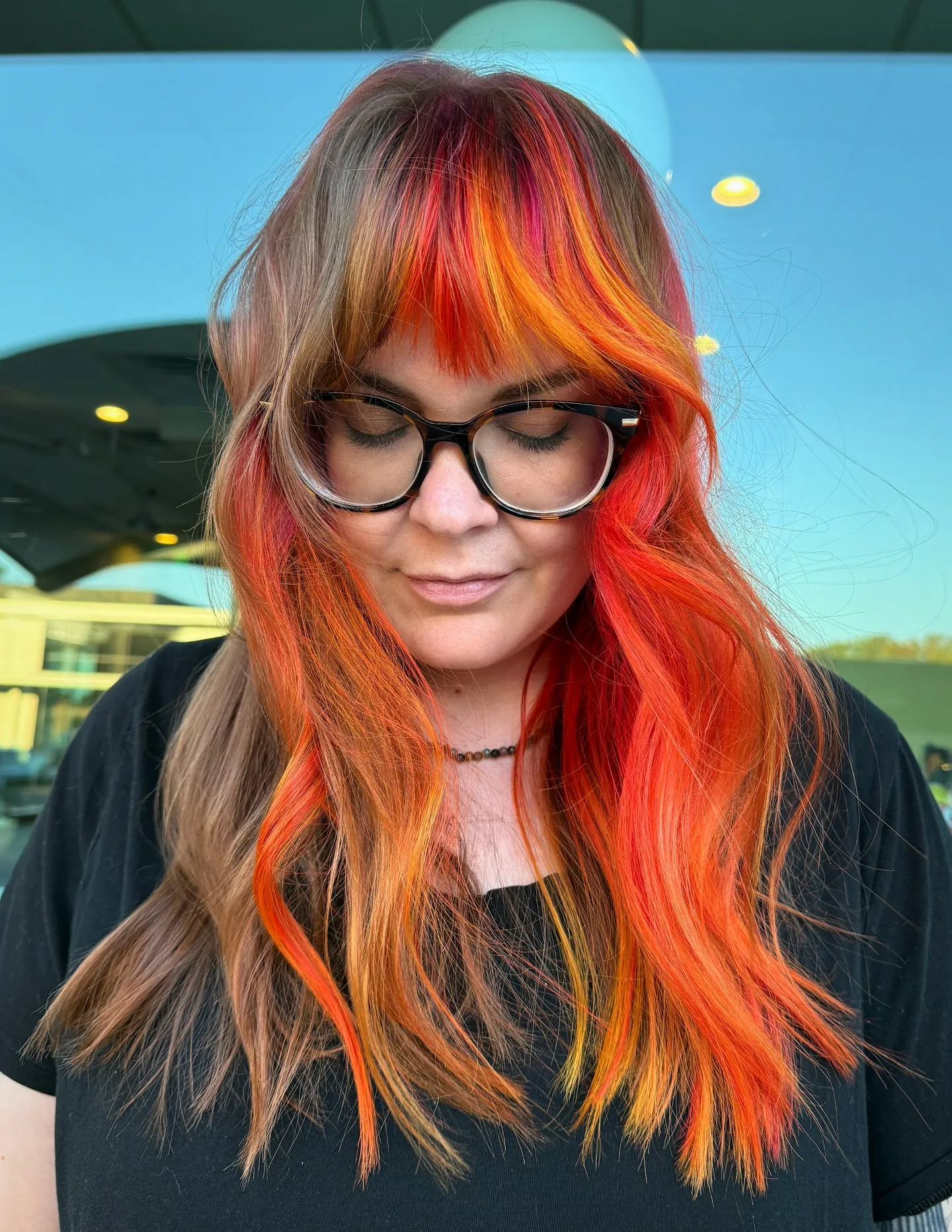 Long layered hair with vivid red and orange fringe panels