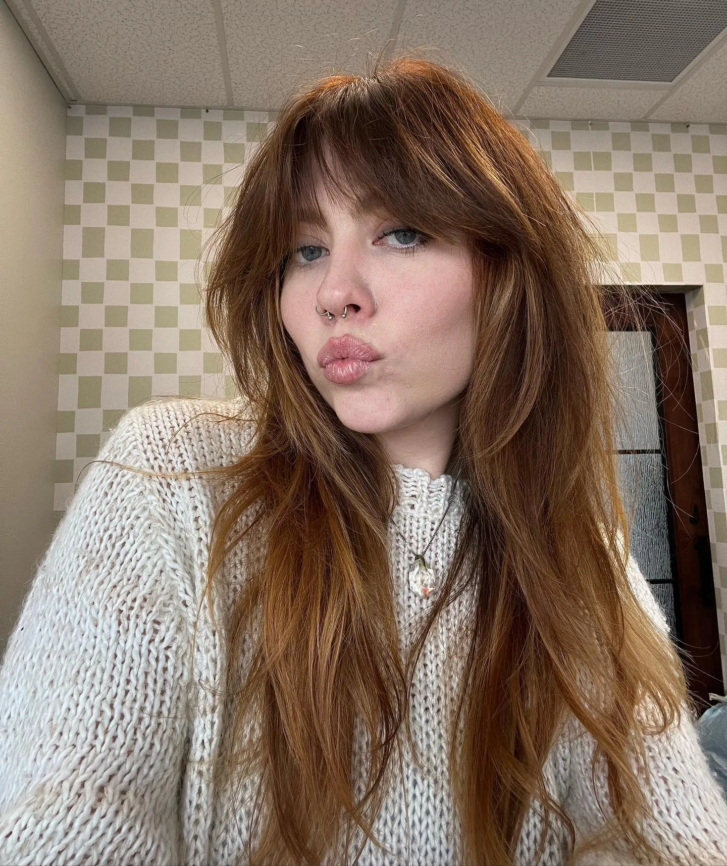 Long shaggy auburn hair with curtain bangs and textured layers