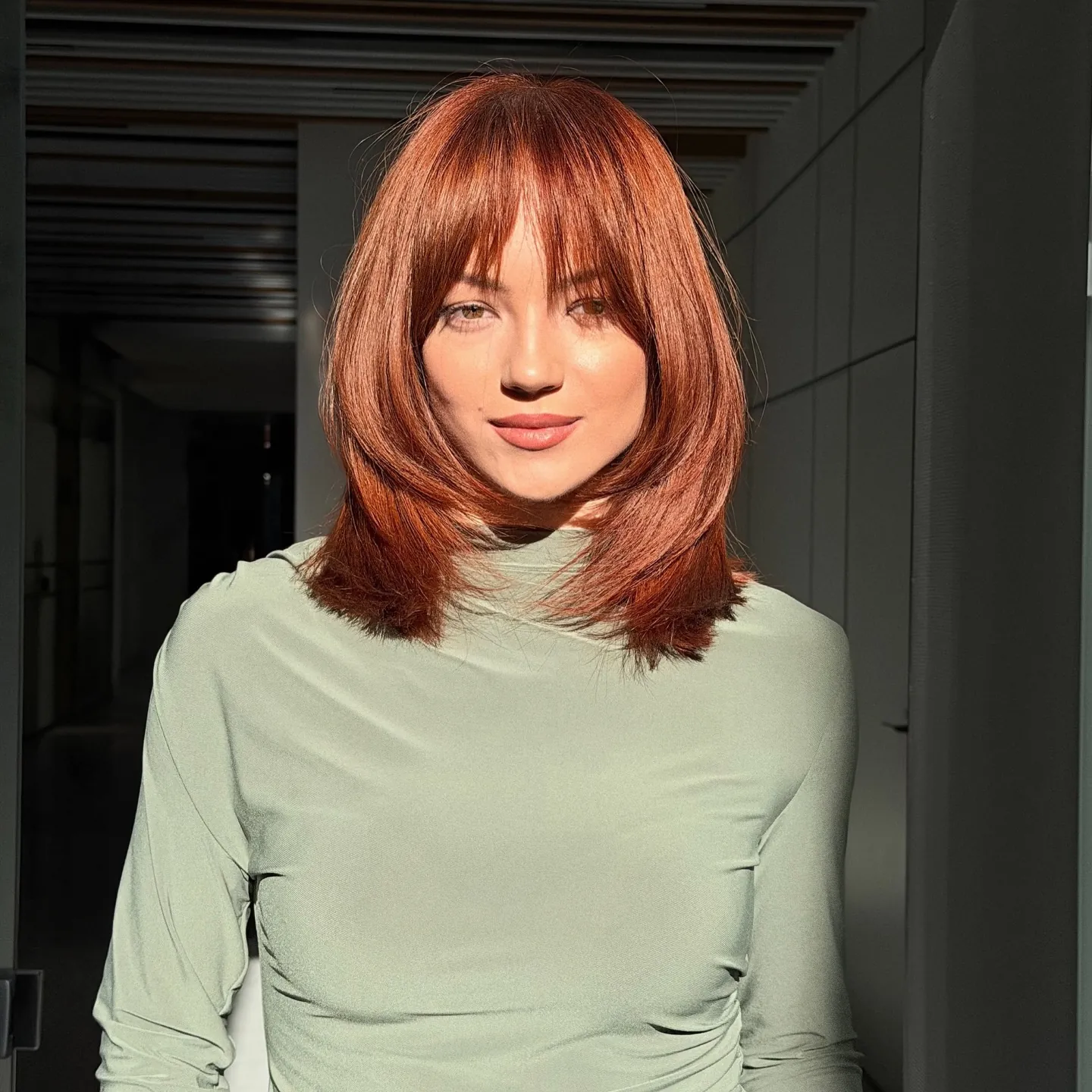 Copper lob with full bangs and curved ends