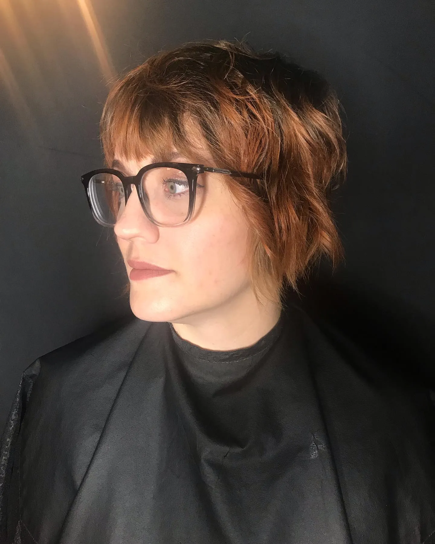 Short copper auburn textured pixie with bangs