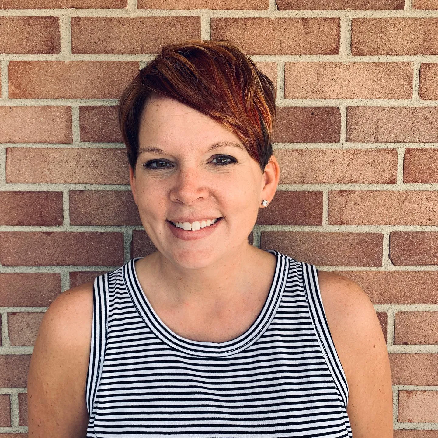 Copper-red pixie with darker roots