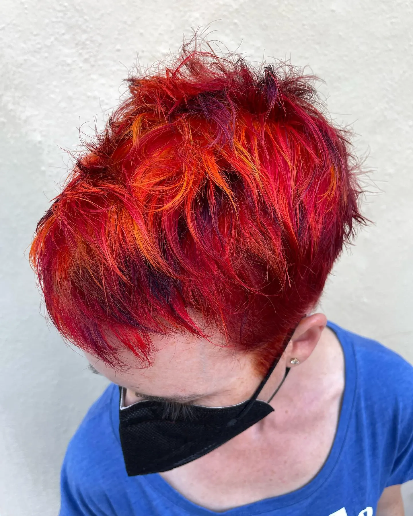 Vibrant red-orange textured pixie with purple lowlights